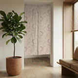 Beige door curtain with a crescent moon, leafy botanical branches, gray line art, and dotted celestial details.