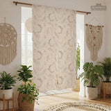 Beige door curtain with a crescent moon, leafy botanical branches, gray line art, and dotted celestial details.