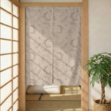 Beige door curtain with a crescent moon, leafy botanical branches, gray line art, and dotted celestial details.