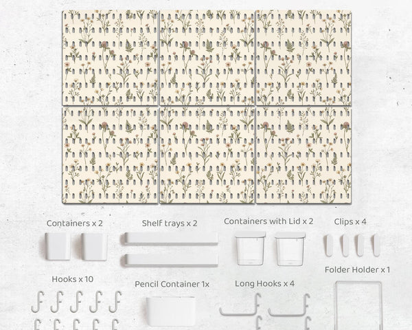 Cream pegboard wall organizer with small floral print, sage green stems, black slot layout, shelves, hooks, clips, and containers.