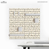 Cream pegboard wall organizer with small floral print, sage green stems, black slot layout, shelves, hooks, clips, and containers.