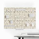 Cream pegboard wall organizer with small floral print, sage green stems, black slot layout, shelves, hooks, clips, and containers.