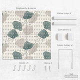 Four pegboard panels in sage green with cream, grey, teal, and leafy botanical artwork arranged in a square layout.