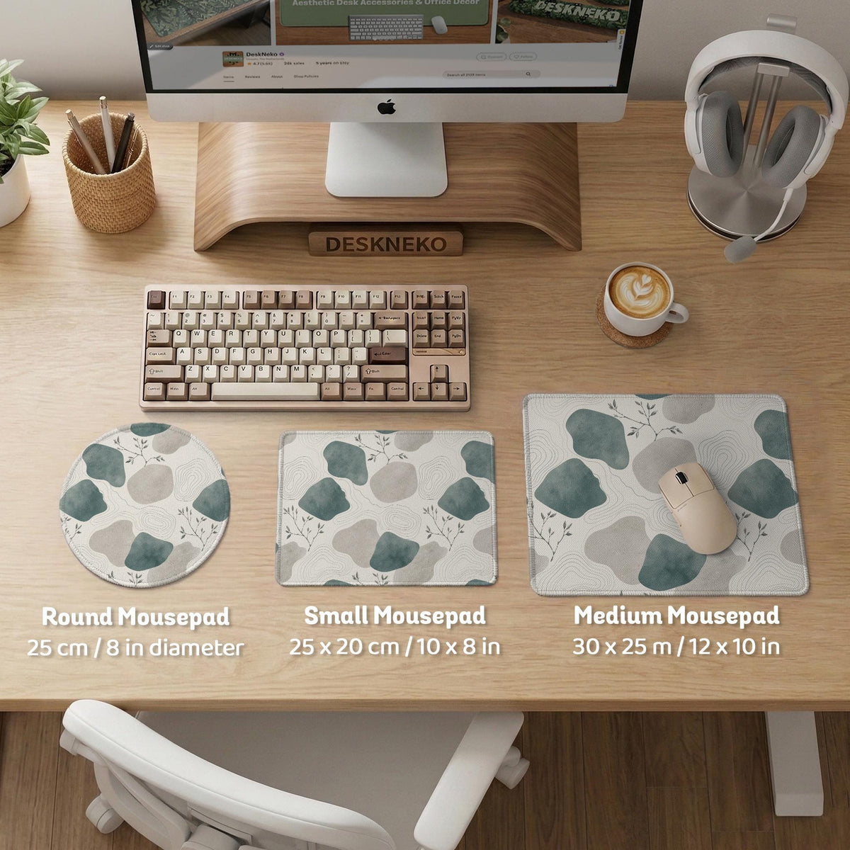 A desk mat with sage green abstract blocks, cream space, gray stone-like shapes, fine topographic contour lines, and small branch details.