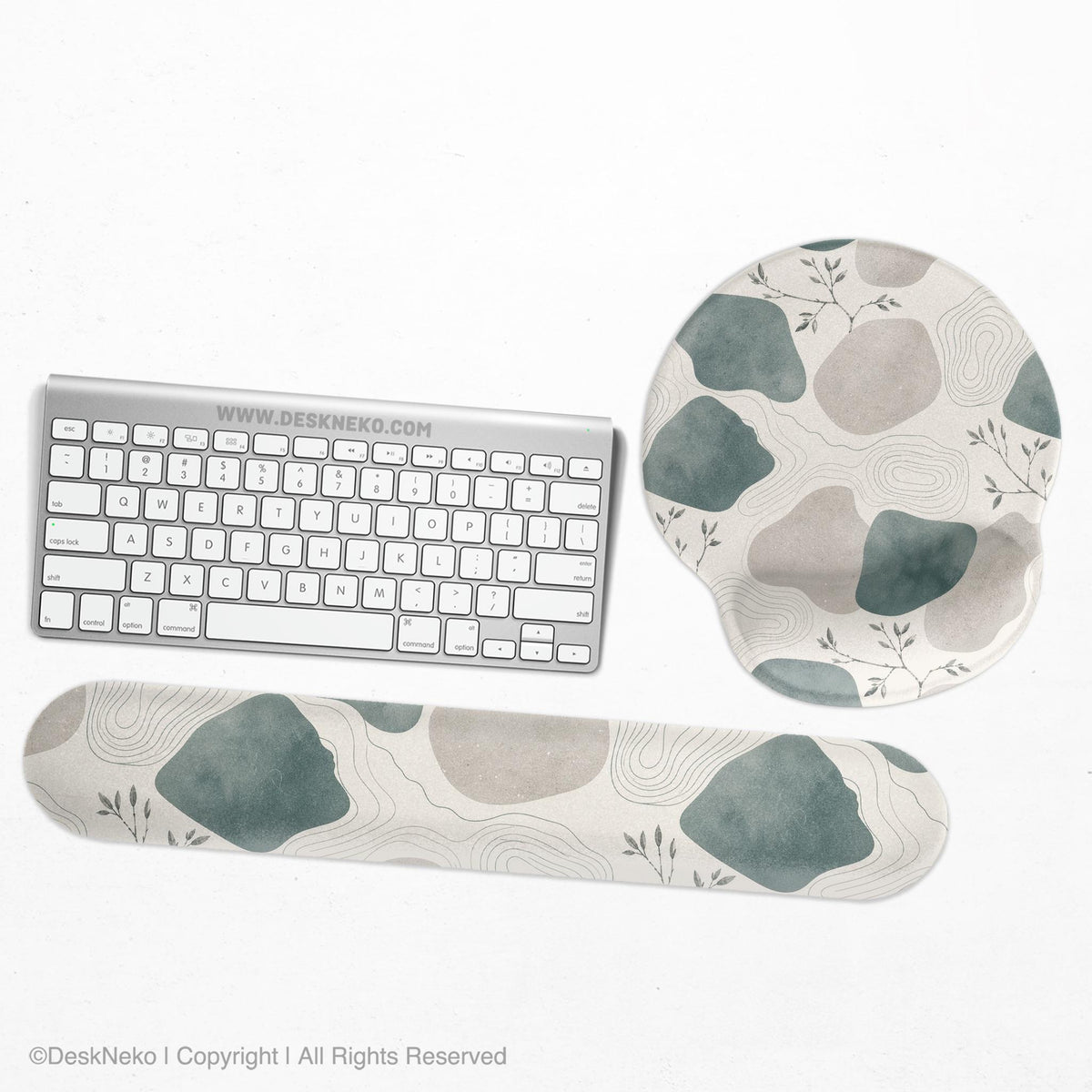 Sage green ergonomic mousepad and keyboard wrist rest with abstract shapes, soft gray details, cream space, topographic contour lines, and leafy branch accents.