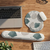 Sage green ergonomic mousepad and keyboard wrist rest with abstract shapes, soft gray details, cream space, topographic contour lines, and leafy branch accents.
