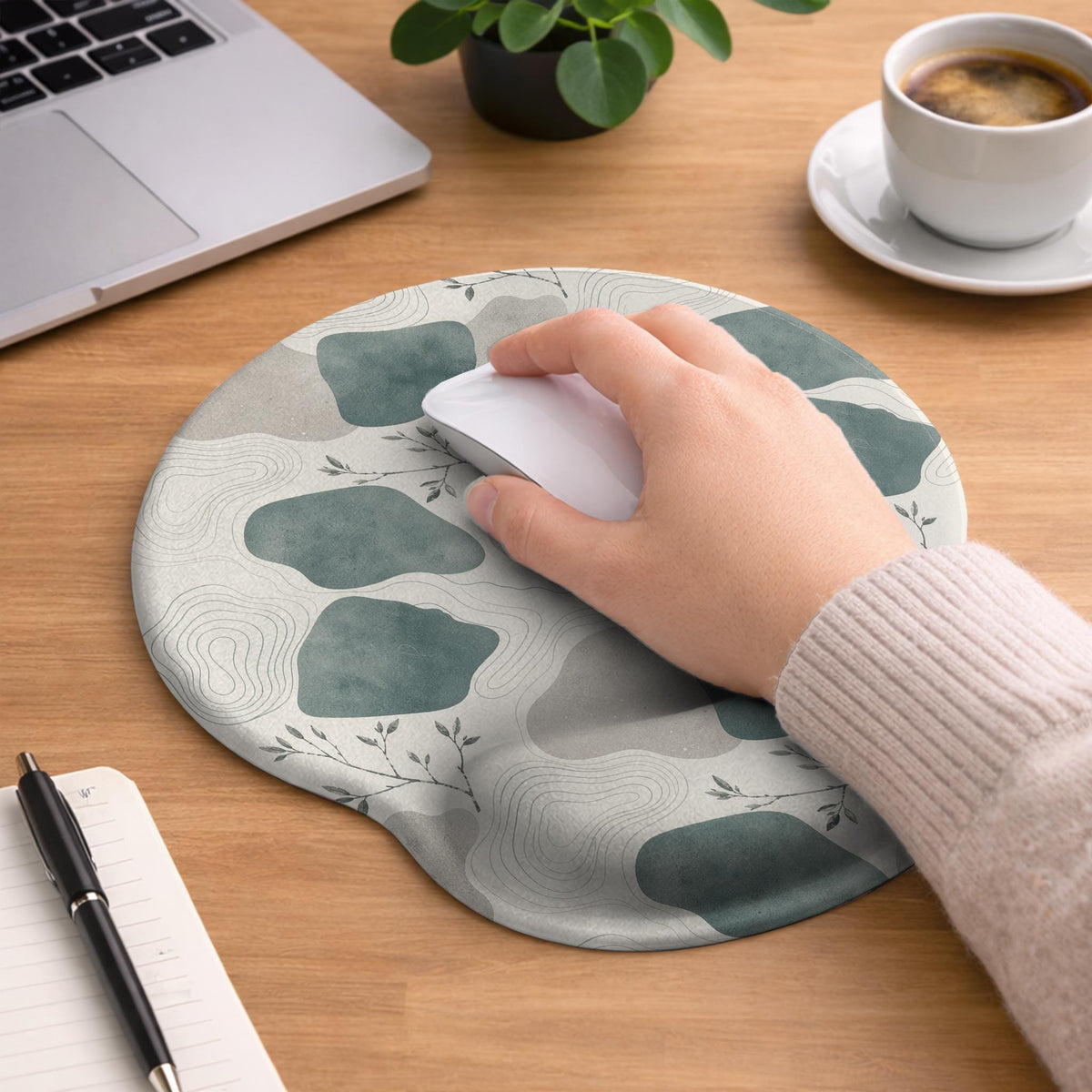 Sage green ergonomic mousepad and keyboard wrist rest with abstract shapes, soft gray details, cream space, topographic contour lines, and leafy branch accents.