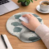 Sage green ergonomic mousepad and keyboard wrist rest with abstract shapes, soft gray details, cream space, topographic contour lines, and leafy branch accents.