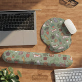 Sage green desk mat with a pattern of lounging cats, leafy plants, cactus pots, and earthy botanical details.