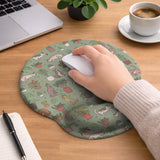 Sage green desk mat with a pattern of lounging cats, leafy plants, cactus pots, and earthy botanical details.