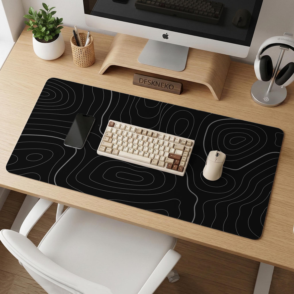 Black desk mat with a thin gray topographic contour line pattern.