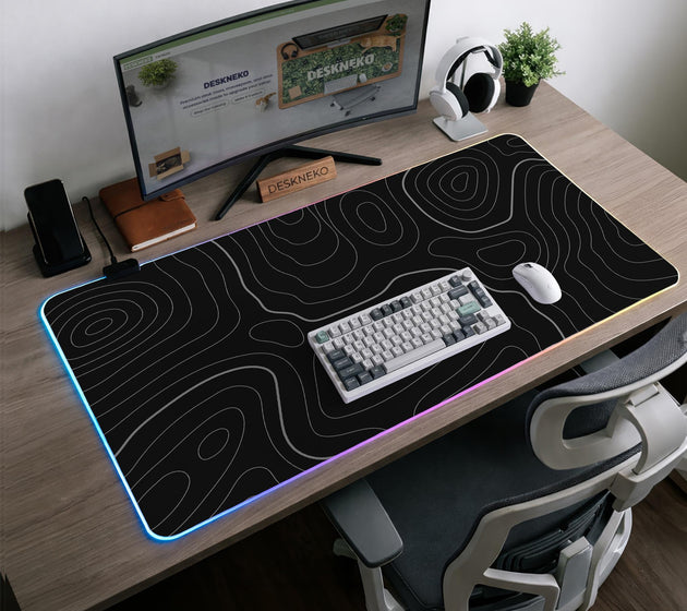 Black desk mat with a thin gray topographic contour line pattern.