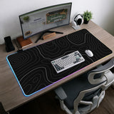 Black desk mat with a thin gray topographic contour line pattern.