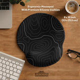 Black desk mat with a thin gray topographic contour line pattern.