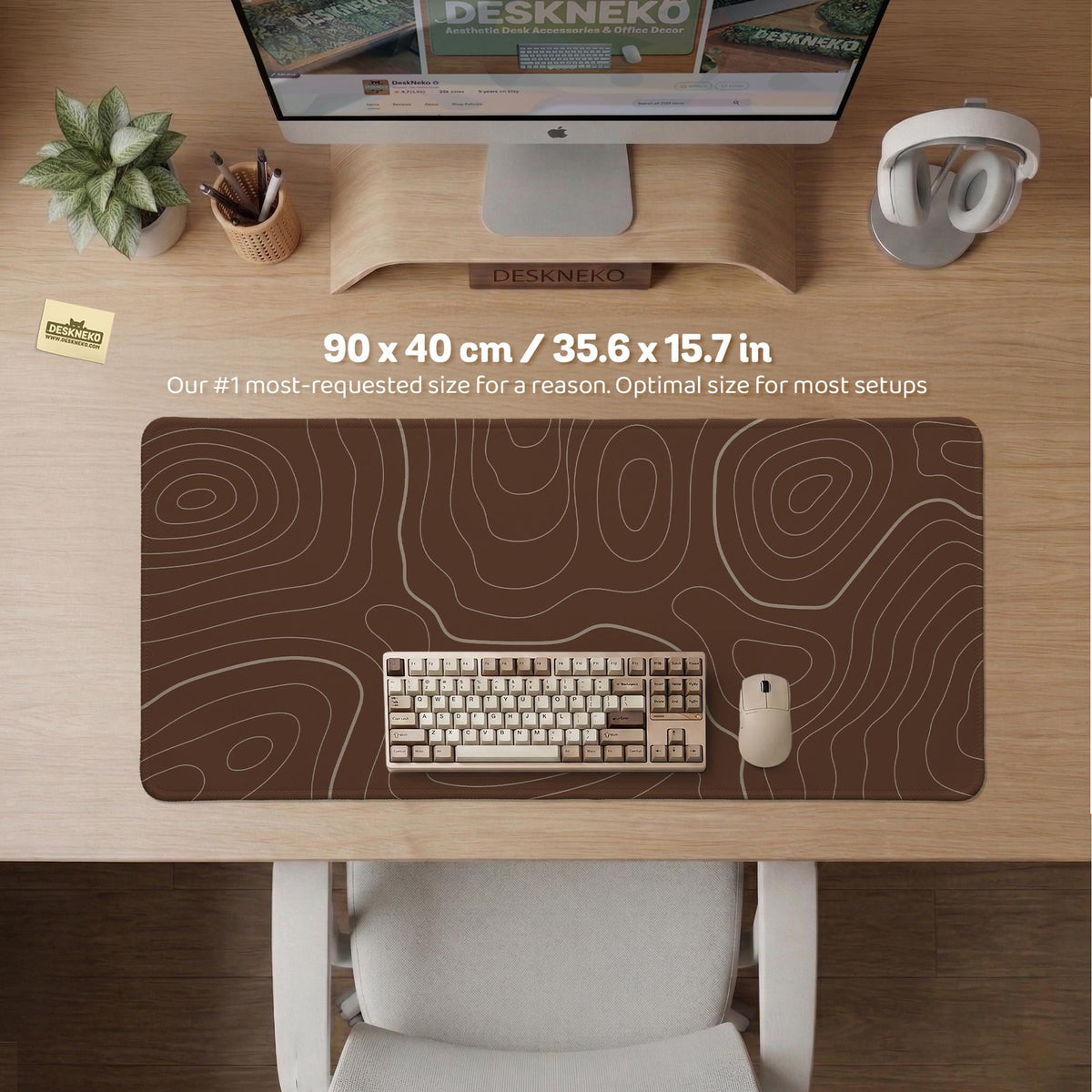 Brown desk mat with a repeating topographic contour line pattern in a neutral earth tone design.