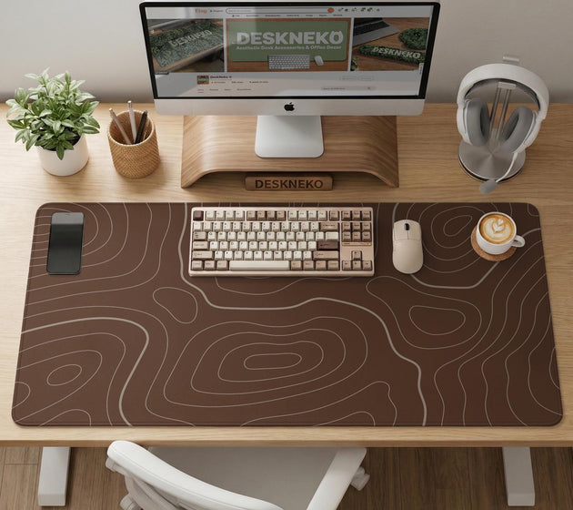 Brown desk mat with a repeating topographic contour line pattern in a neutral earth tone design.