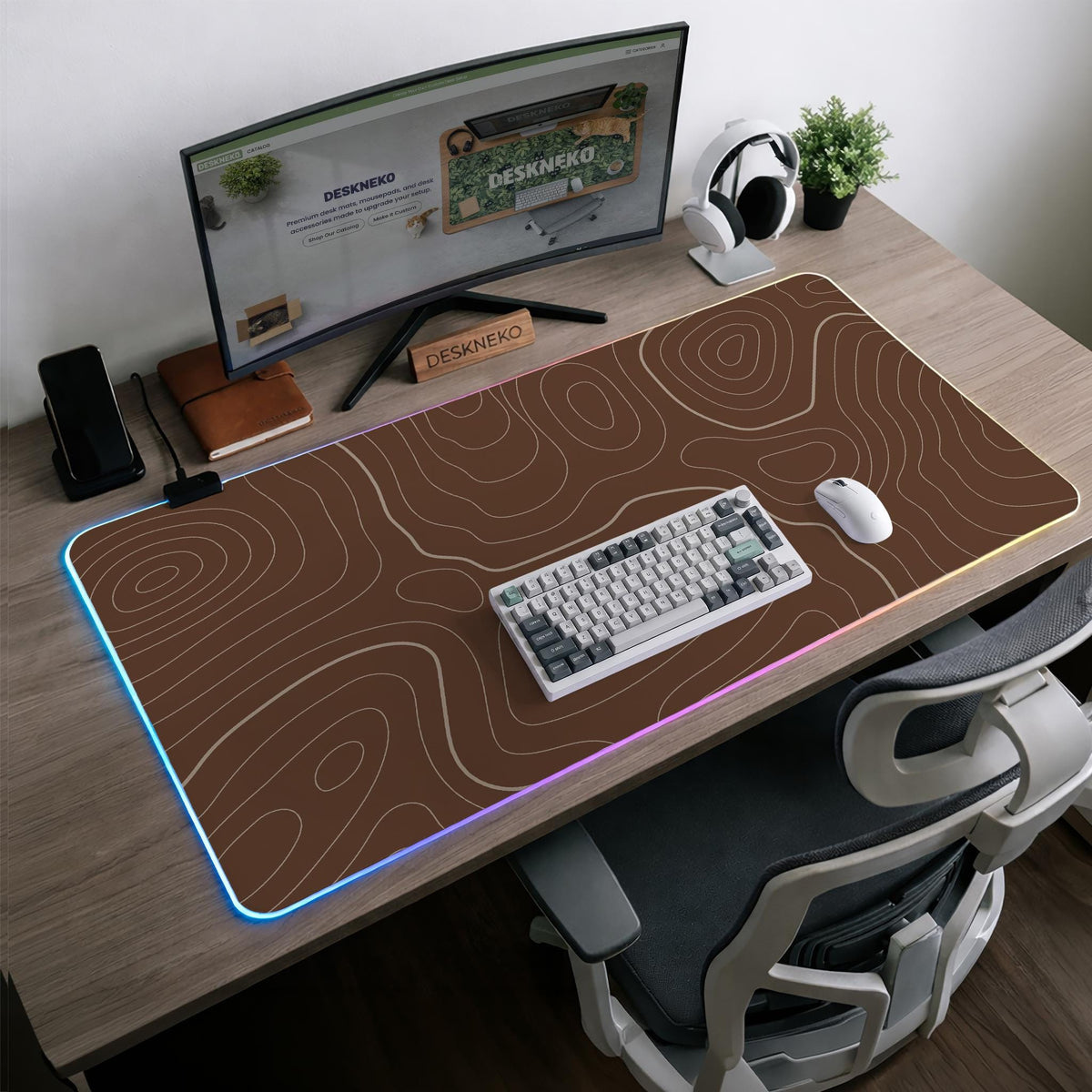 Brown desk mat with a repeating topographic contour line pattern in a neutral earth tone design.
