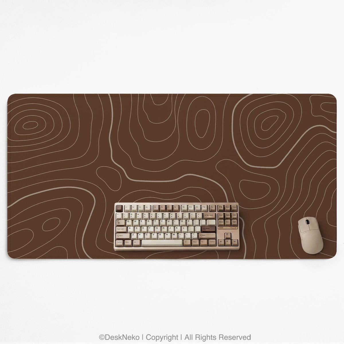Brown desk mat with a repeating topographic contour line pattern in a neutral earth tone design.
