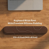 Brown desk mat with a repeating topographic contour line pattern in a neutral earth tone design.