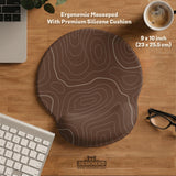 Brown mousepad and keyboard wrist rest with a topographic contour-line pattern.