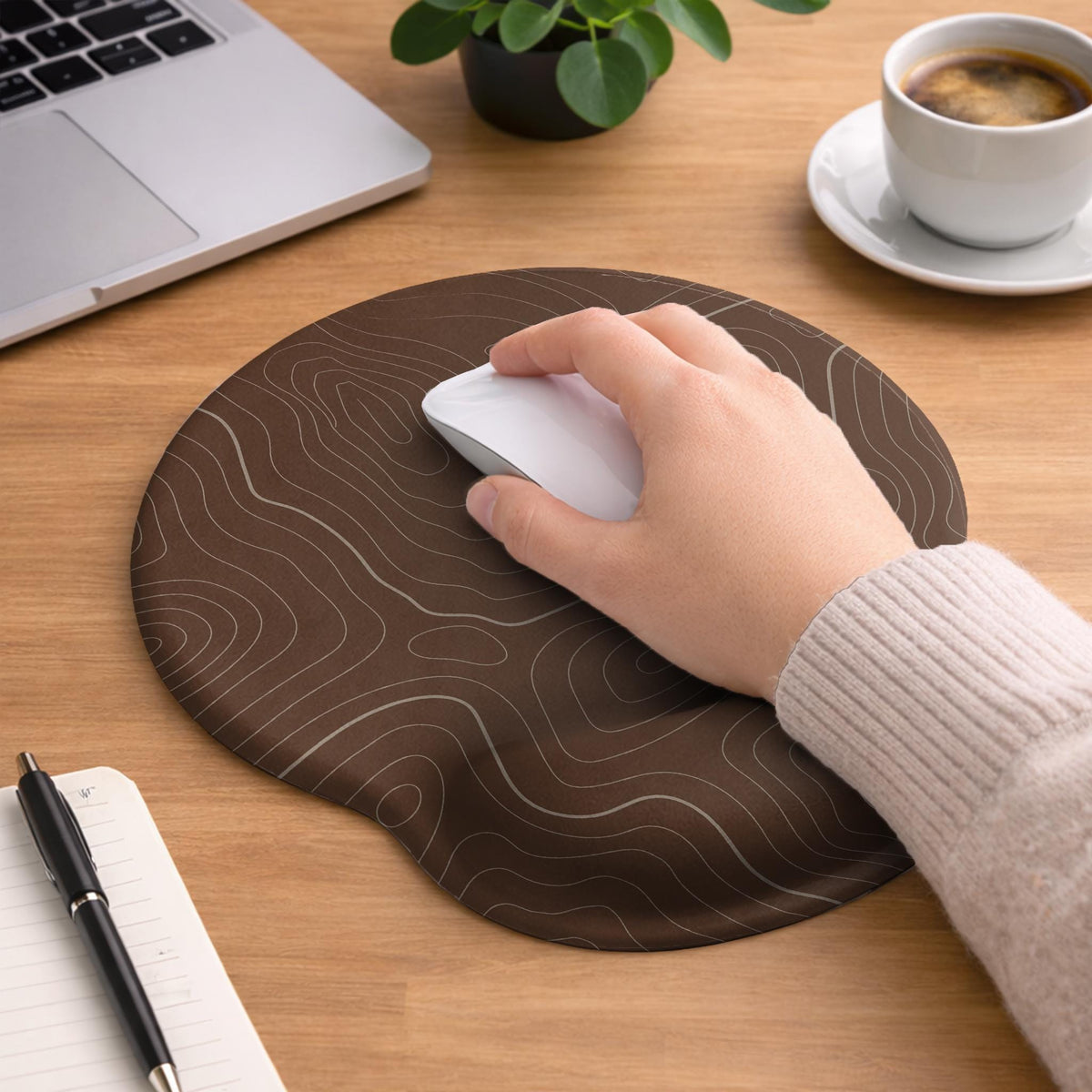Brown mousepad and keyboard wrist rest with a topographic contour-line pattern.
