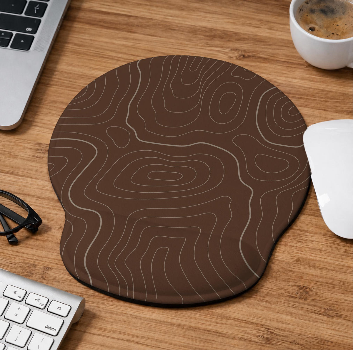 Brown mousepad and keyboard wrist rest with a topographic contour-line pattern.