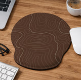 Brown mousepad and keyboard wrist rest with a topographic contour-line pattern.