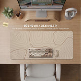 Beige desk mat with soft brown topographic contour lines on a neutral background.