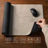 A beige mousepad with a topographic line pattern in a repeating design.