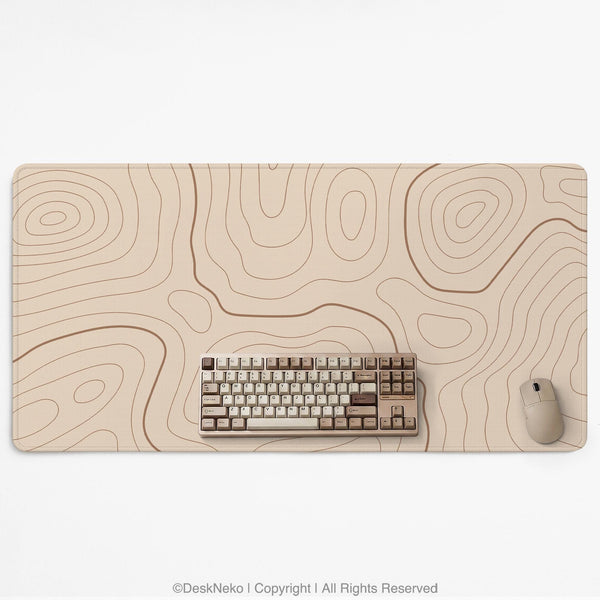 Beige desk mat with soft brown topographic contour lines on a neutral background.