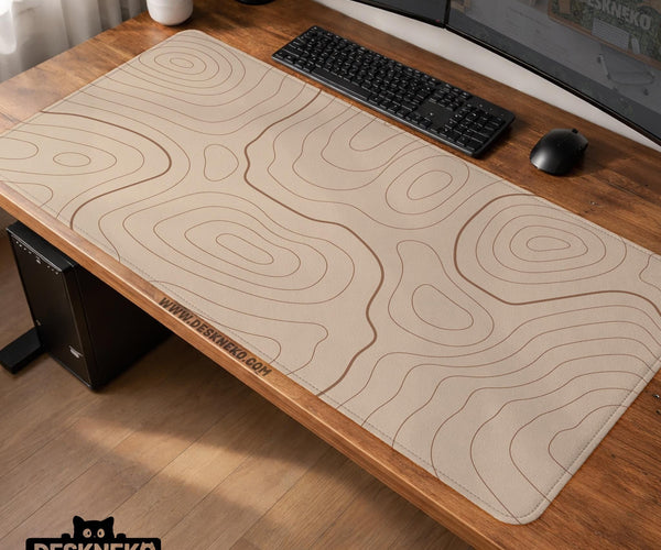 A beige mousepad with a topographic line pattern in a repeating design.