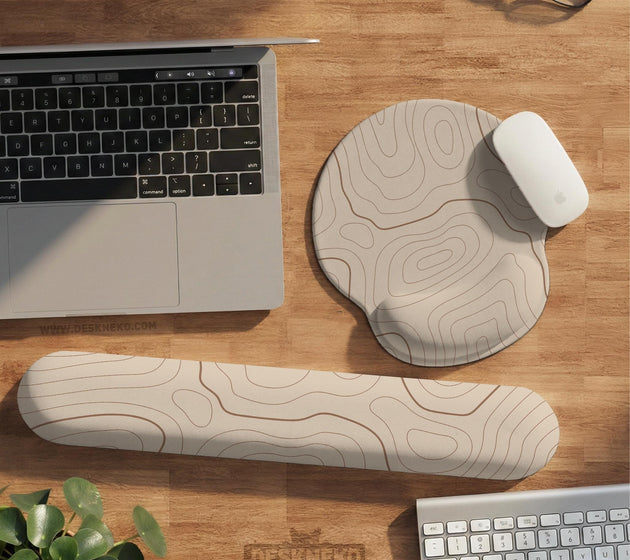 Beige mousepad and keyboard wrist rest with a topographic line pattern shown in a neutral desk setup.