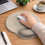 Beige mousepad and keyboard wrist rest with a topographic line pattern shown in a neutral desk setup.