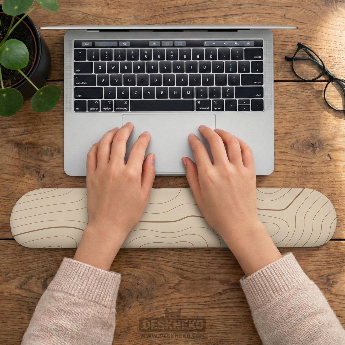 Beige mousepad and keyboard wrist rest with a topographic line pattern shown in a neutral desk setup.