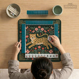 Dark green square mahjong mat with a golden spotted leopard in the center, surrounded by flowers, leafy stems, butterflies, and small star accents.
