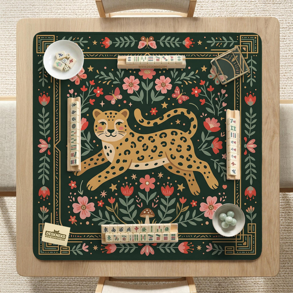 Dark green square mahjong mat with a golden spotted leopard in the center, surrounded by flowers, leafy stems, butterflies, and small star accents.