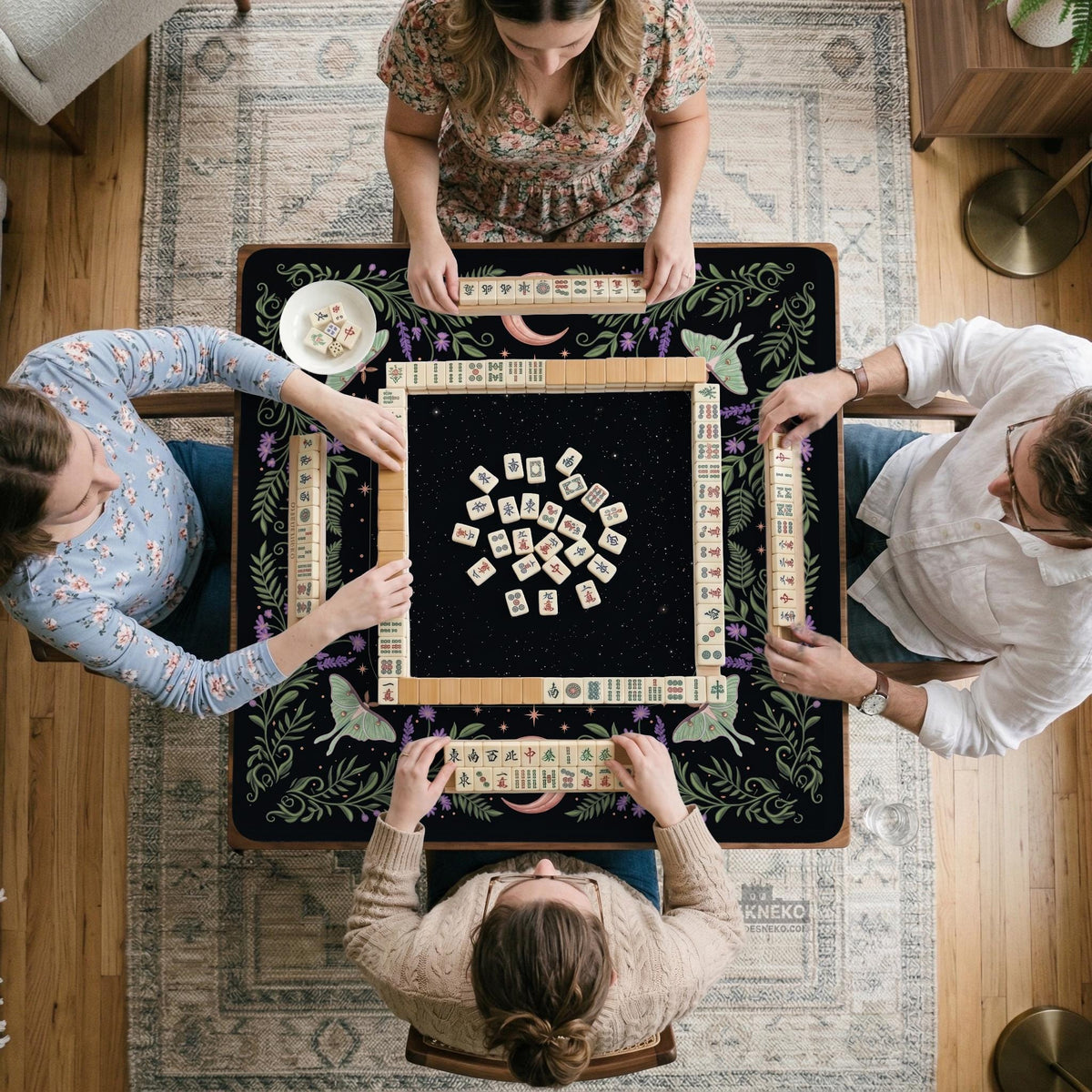 Black mahjong table mat with luna moths, purple flowers, soft green leaves, copper moons, and small star details.