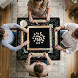 Black mahjong table mat with luna moths, purple flowers, soft green leaves, copper moons, and small star details.