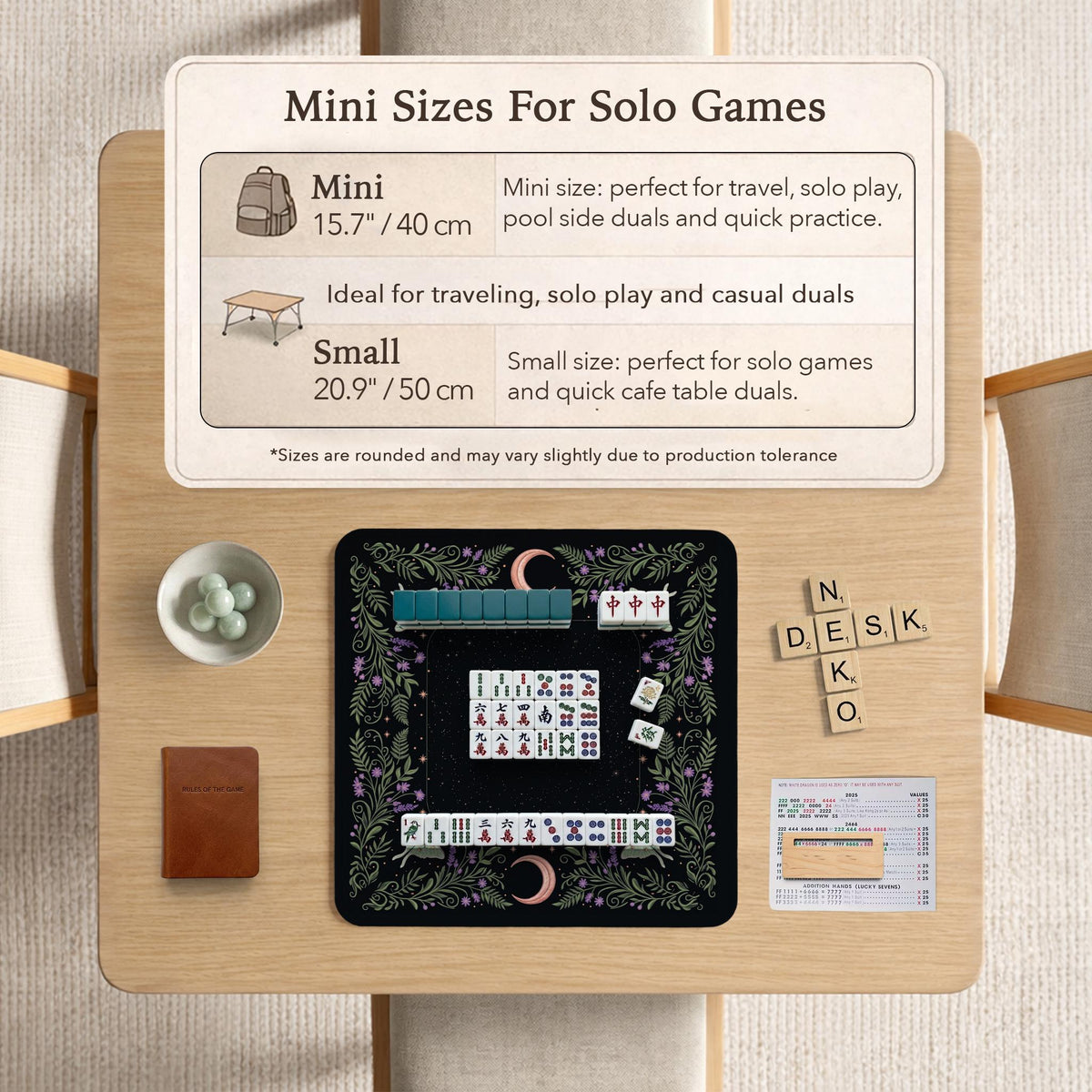 Black mahjong table mat with luna moths, purple flowers, soft green leaves, copper moons, and small star details.