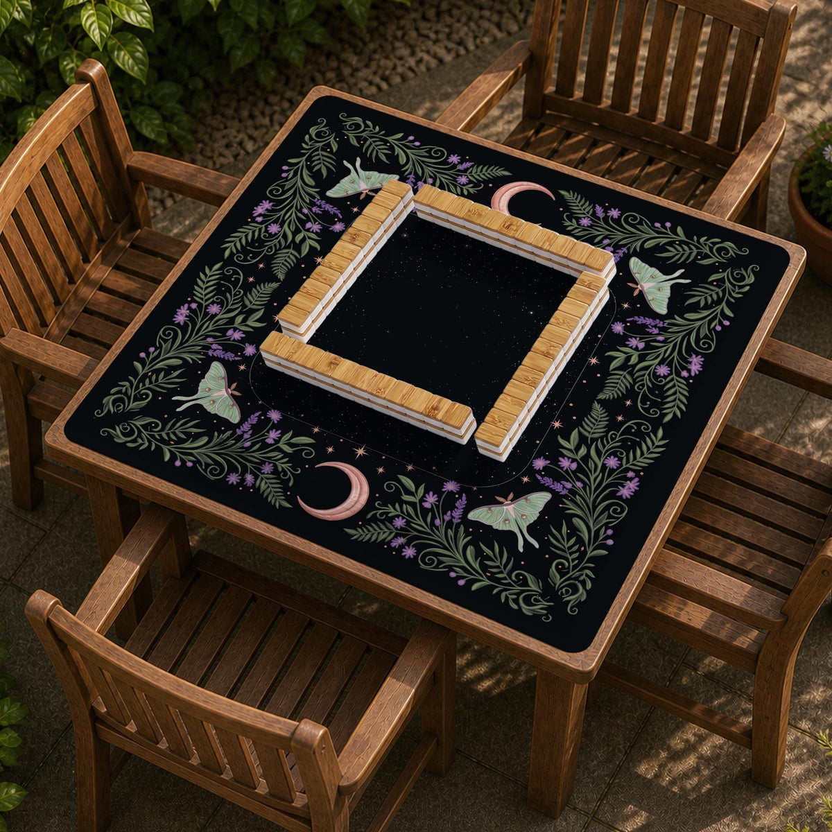 Black mahjong table mat with luna moths, purple flowers, soft green leaves, copper moons, and small star details.