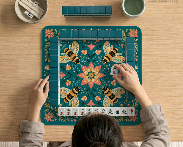 Green mahjong mat with a botanical bee and floral mandala design in teal, coral, cream, and gold.