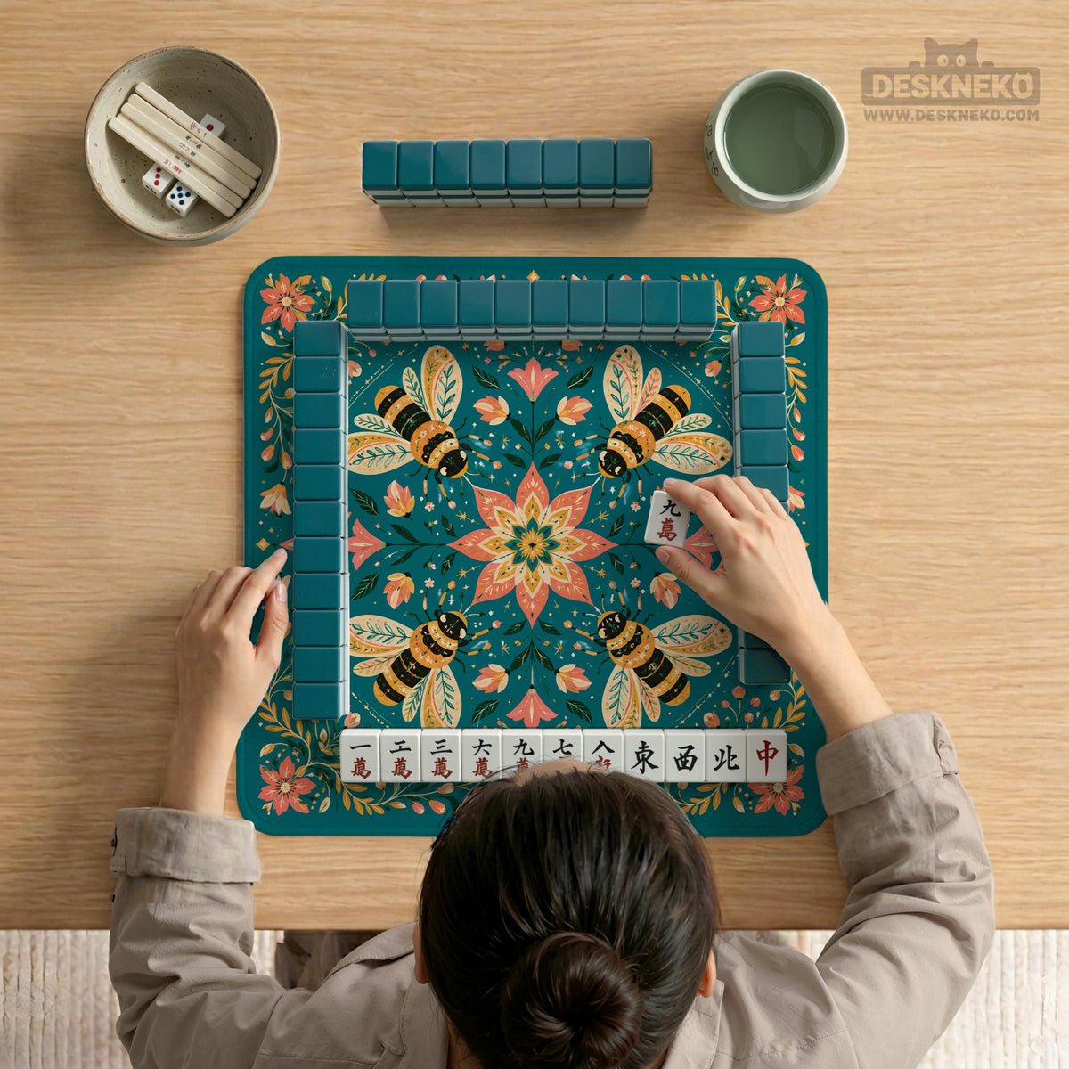 Green mahjong mat with a botanical bee and floral mandala design in teal, coral, cream, and gold.