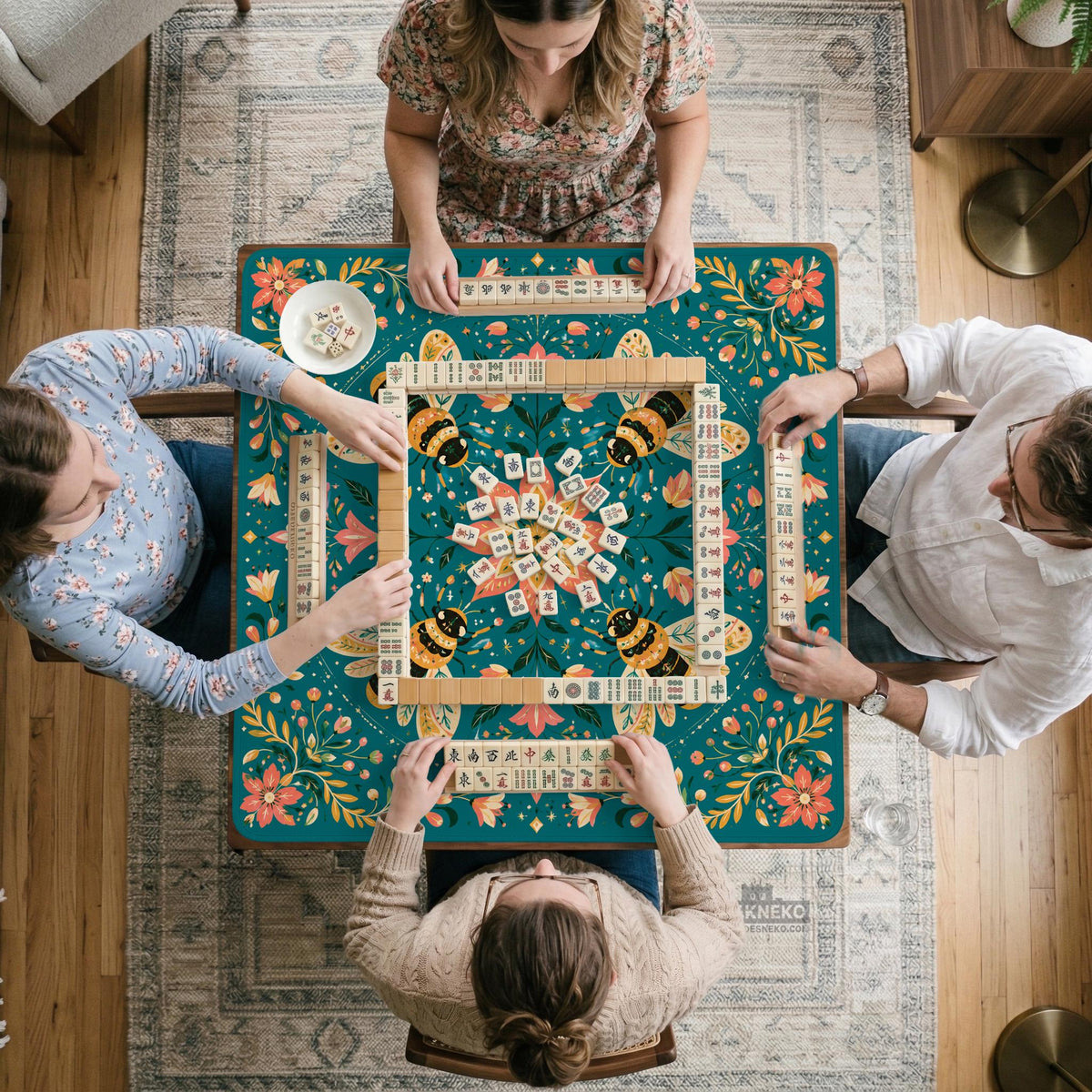 Green mahjong mat with a botanical bee and floral mandala design in teal, coral, cream, and gold.
