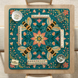 Green mahjong mat with a botanical bee and floral mandala design in teal, coral, cream, and gold.