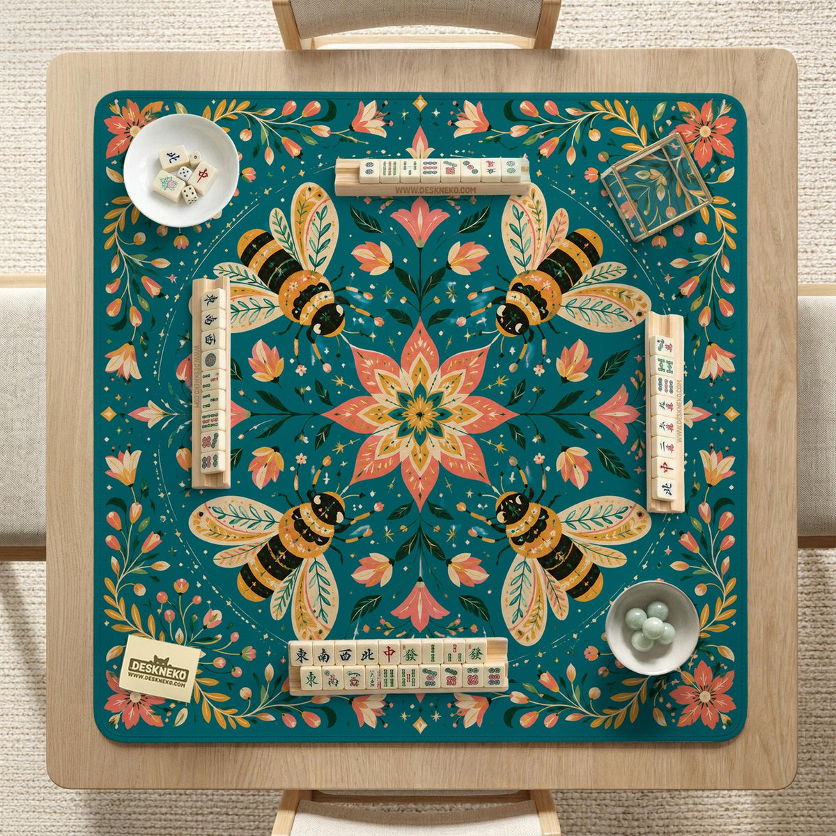 Green mahjong mat with a botanical bee and floral mandala design in teal, coral, cream, and gold.