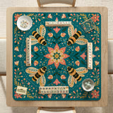 Green mahjong mat with a botanical bee and floral mandala design in teal, coral, cream, and gold.