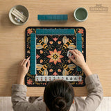 Black mahjong mat with a symmetrical botanical design, coral flowers, golden leaves, and small bees.