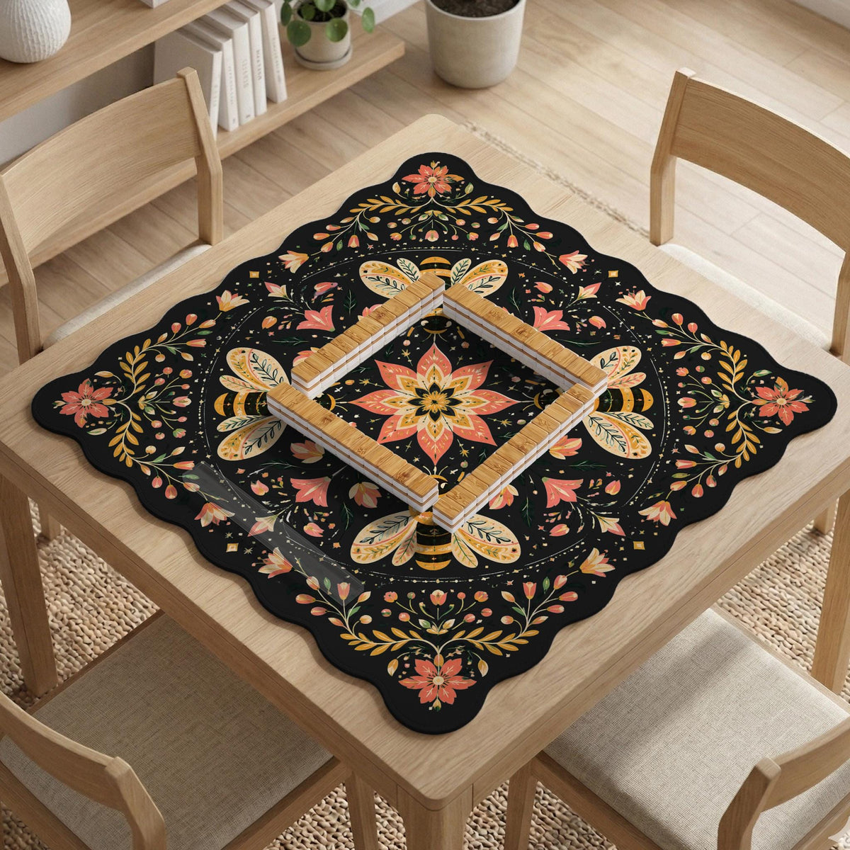 Black mahjong mat with a symmetrical botanical design, coral flowers, golden leaves, and small bees.