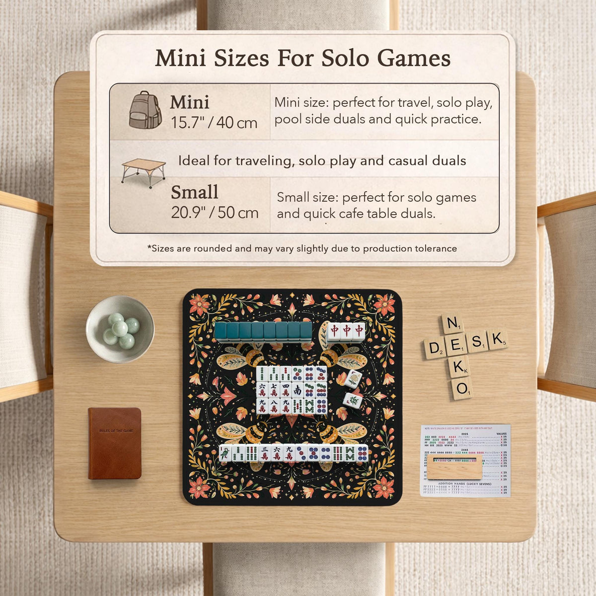 Black mahjong mat with a symmetrical botanical design, coral flowers, golden leaves, and small bees.