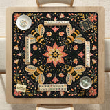 Black mahjong mat with a symmetrical botanical design, coral flowers, golden leaves, and small bees.